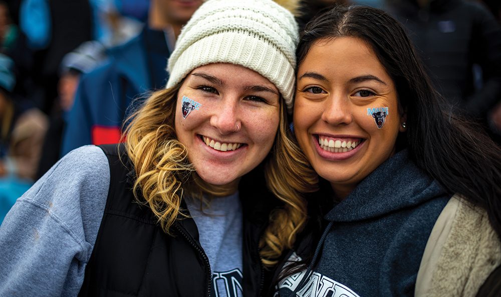 Two students smiling