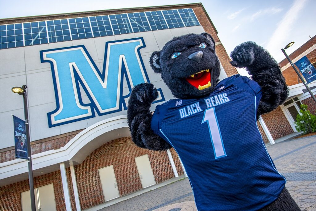 The University of Maine mascot Bananas the Bear, standing in front of the memorial field house