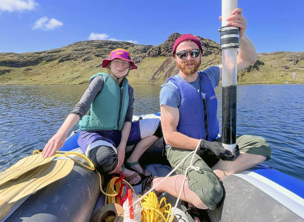 A photo of two people in a raft taking a soil sample