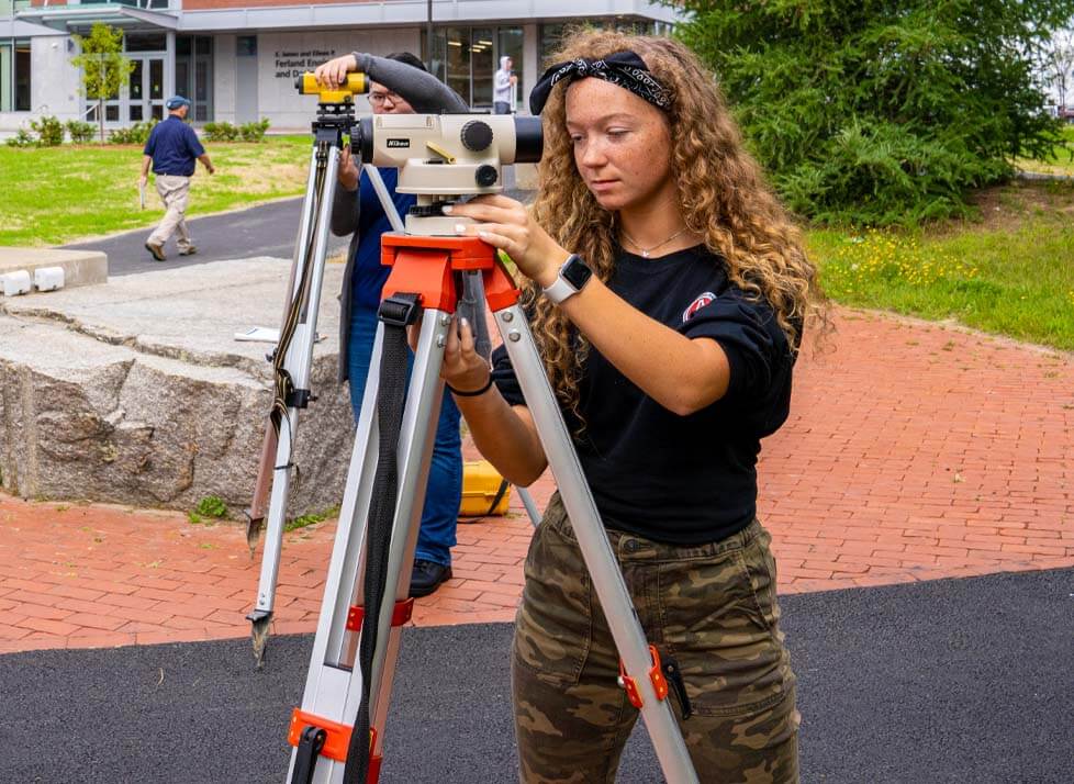 A photo of a student using surveying equipment