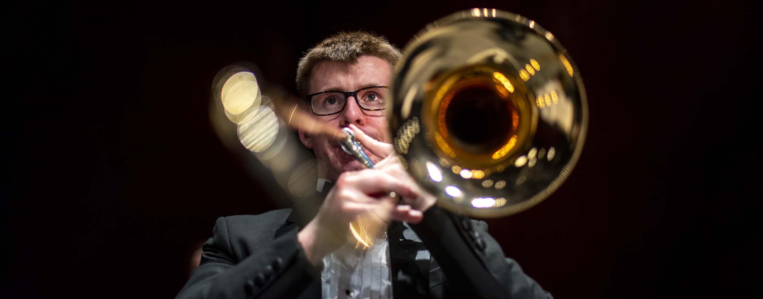 A photo of a music student playing a trombone