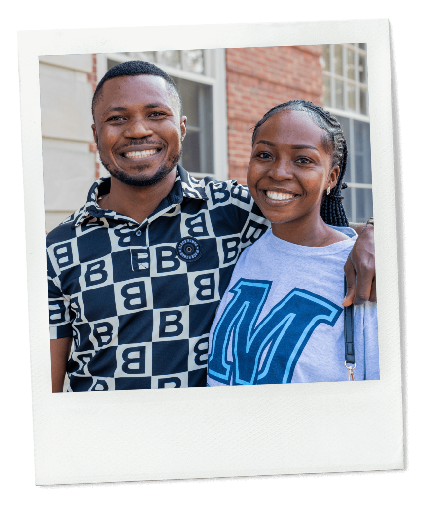 A photo of two people smiling at the camera