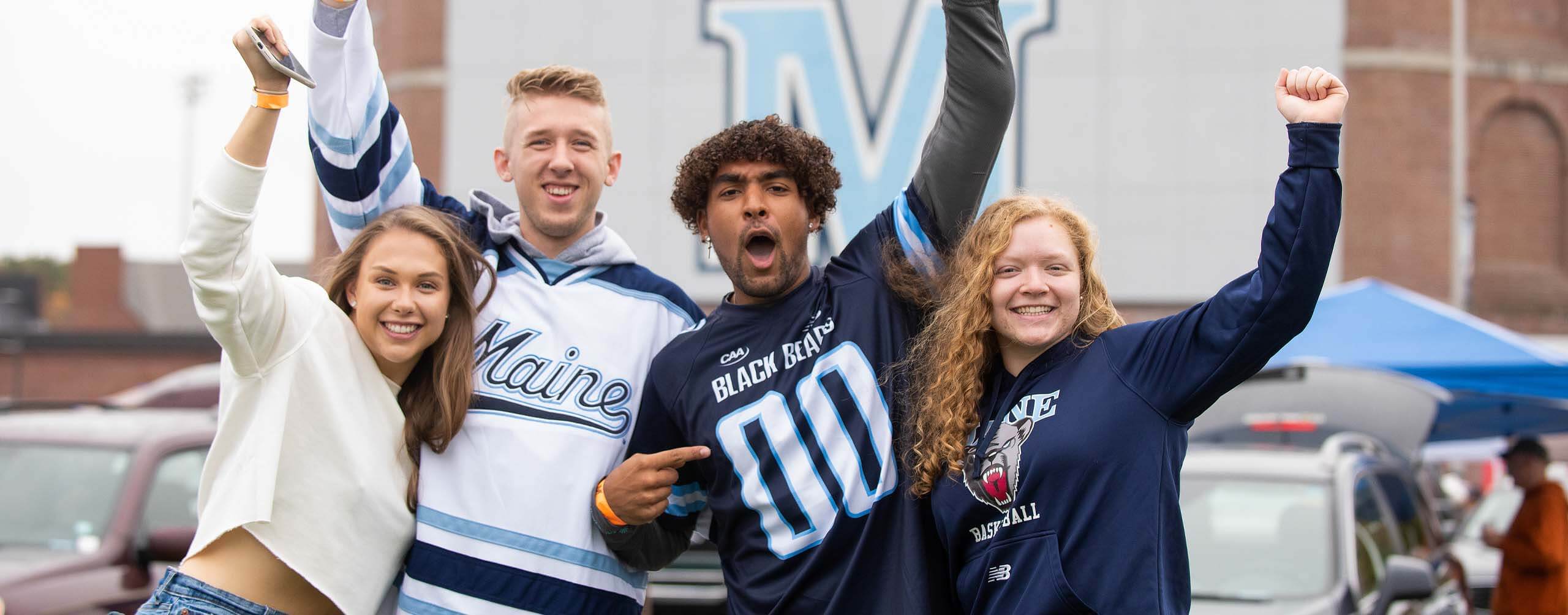 A photo of four people at tailgating before a football game