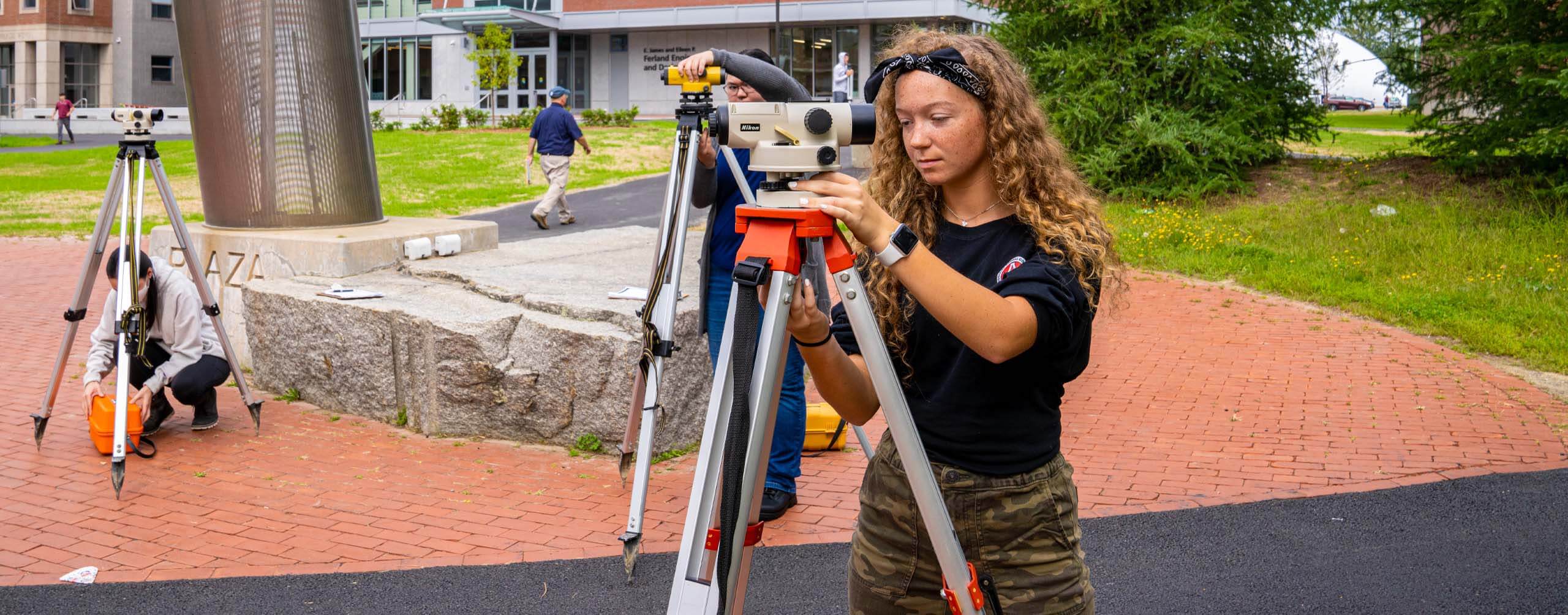 A photo of a student using surveying equipment