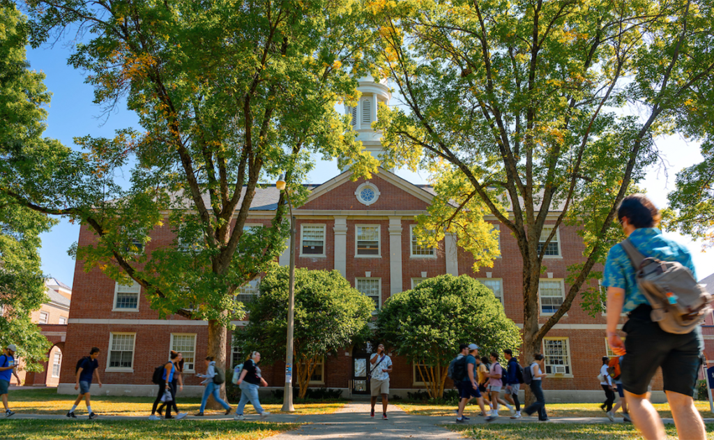 A photo of students walking through the UMaine mall